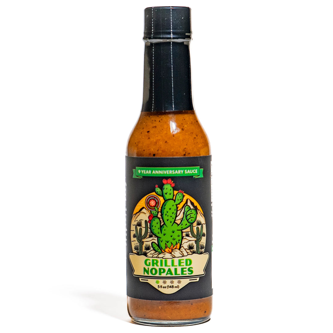 A bottle of Paulman Acre Grilled Nopales Hot Sauce with a label featuring a green cactus and the text '9th Anniversary Sauce'.