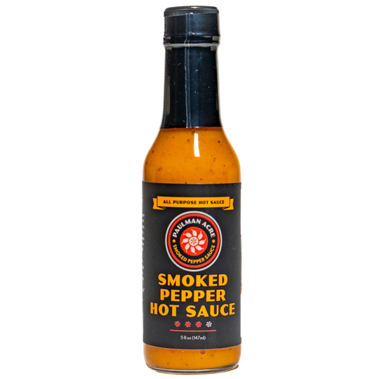 Bottle of smoked pepper hot sauce on a white background